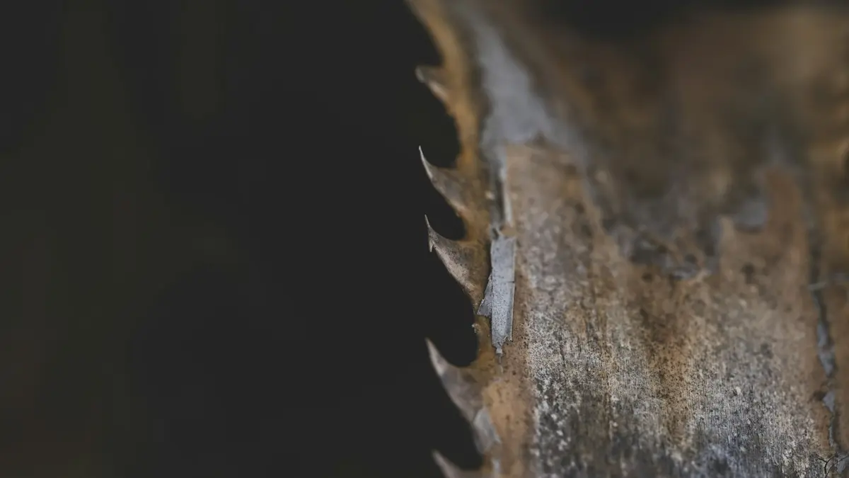 Close-up of a damaged hole saw with visible wear on the cutting edges.