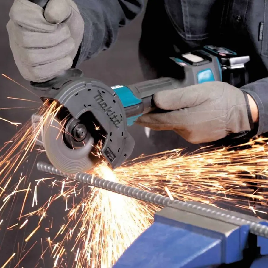 Using an angle grinder to cut metal rebar, creating sparks.